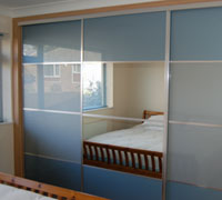 Blue and grey glass and mirror sliding doors